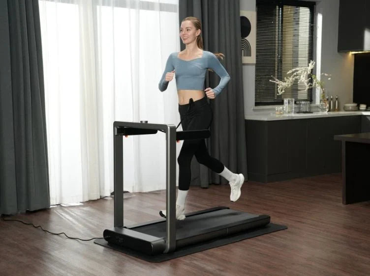 Woman jogging on WalkingPad Foldable Treadmill at home.