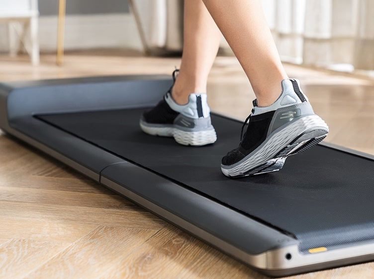 Close-up of walking on a compact walking pad for low-impact home cardio