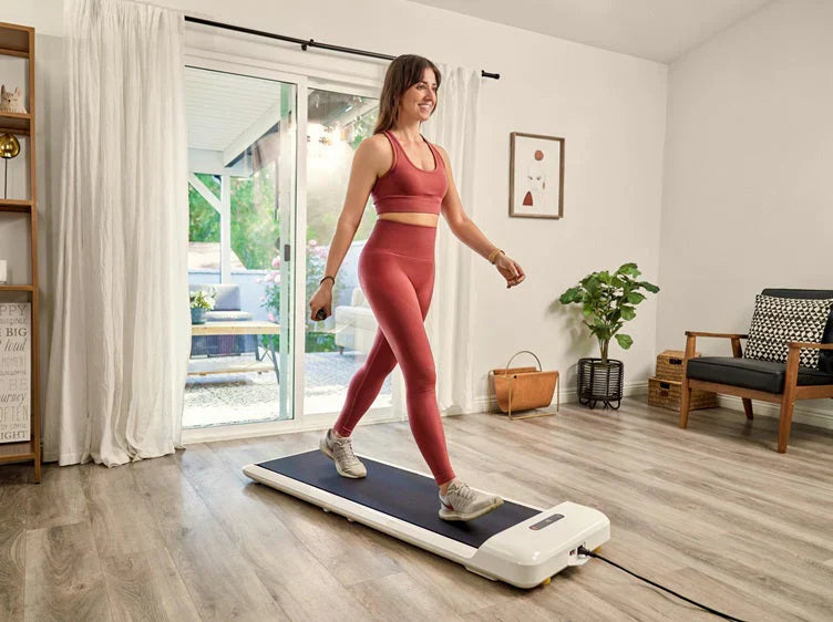 Woman walking on the WalkingPad C2 walking pad in a bright modern living room